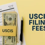 USCIS filing fees graphic showing Form I-912 (Request for Fee Waiver), U.S. dollar bills in a holder labeled “USCIS,” a pen, and the text “USCIS FILING FEES” on a yellow background.